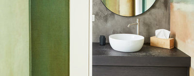 Modern bathroom with a round mirror, vessel sink, and tissue box: Photo by The Juggle Studio